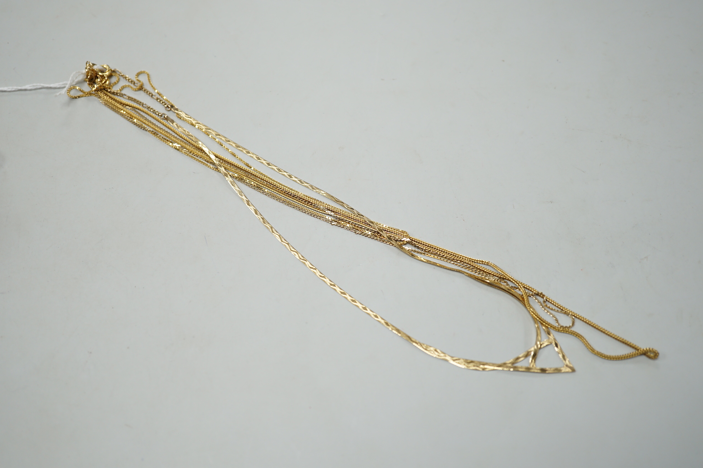 Two modern 9ct gold chains, longest 50cm, 6.3 grams, a 14k chain, 46cm, 2.6 grams and a 750 yellow metal chain, 38cm, 3.5 grams.